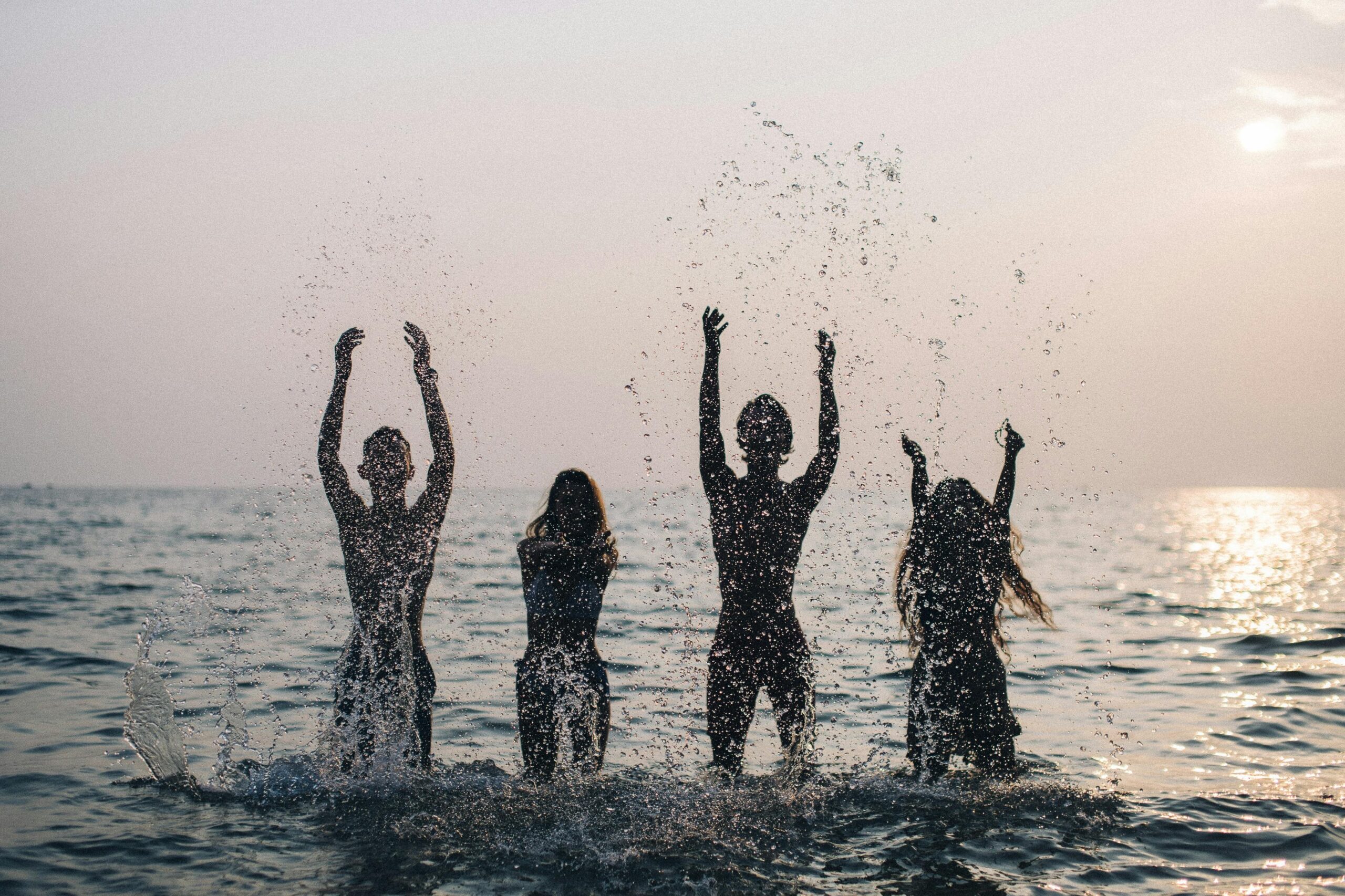A group of happy travelers protected by their durable ponchos in a storm
