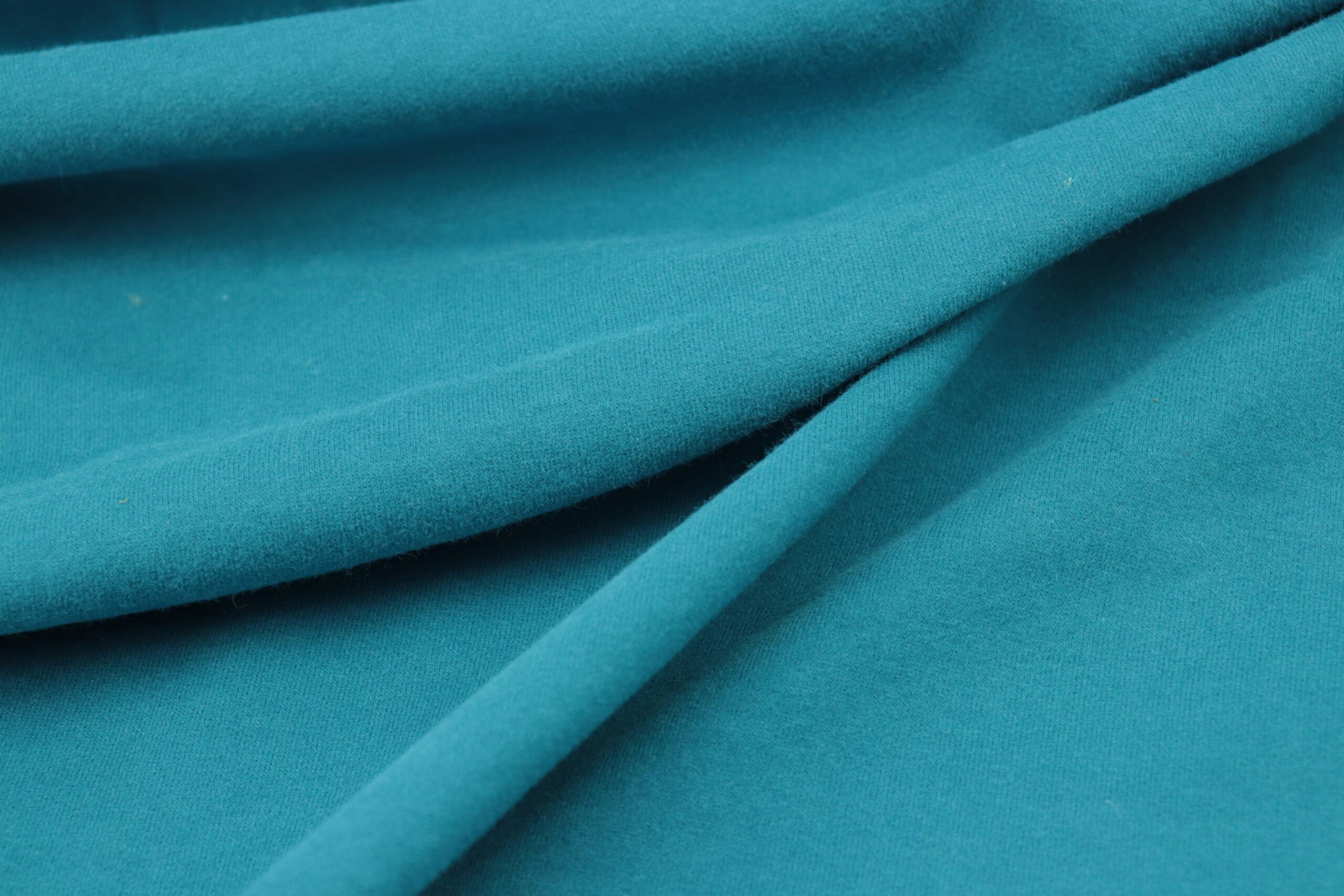 Close-up shot of different fabric types used in making high-quality hooded rain ponchos.