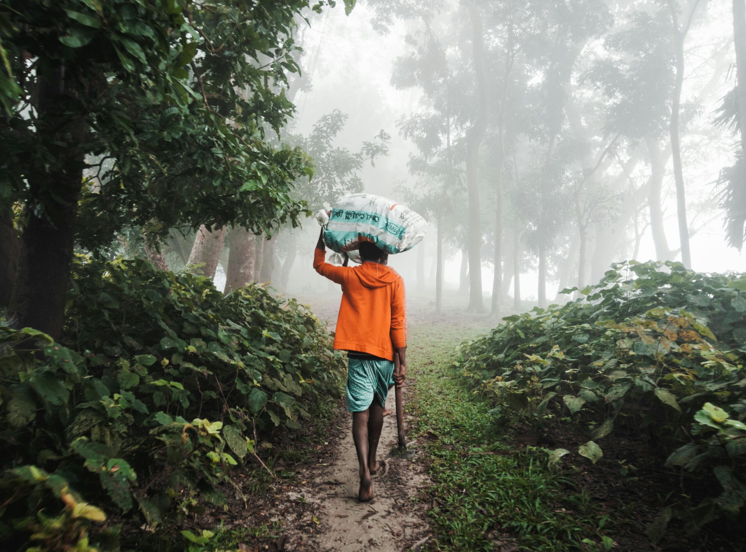 Happy traveler wearing a sleek black poncho amidst light rain