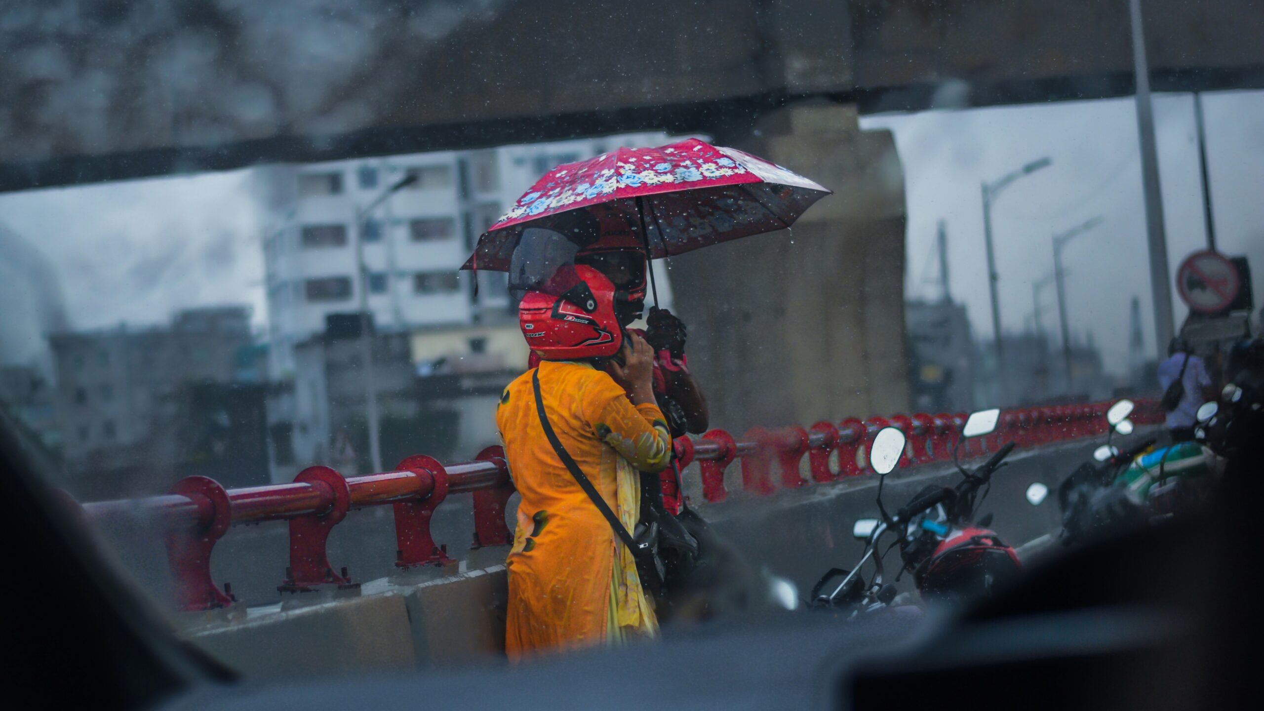 A happy hiker using a bright yellow poncho while walking in light drizzle