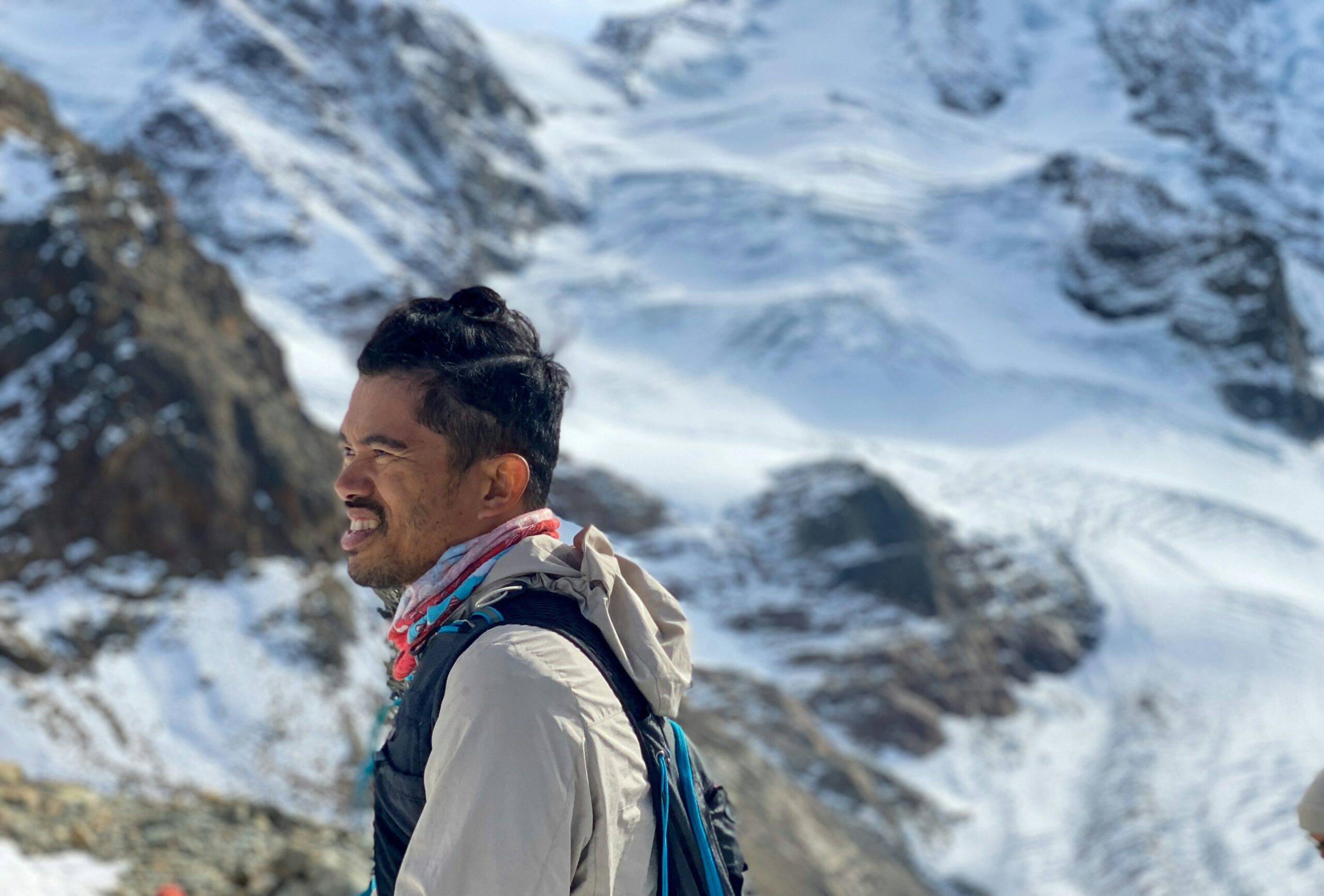 Smiling traveler wearing poncho amid scenic landscape